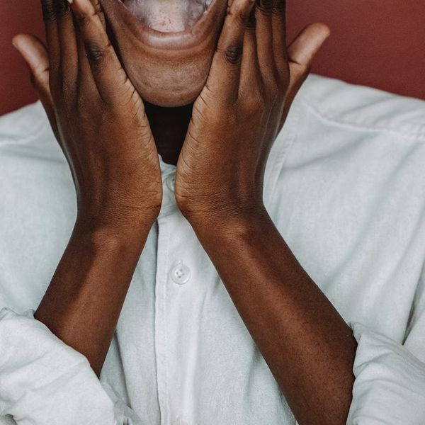 Smiling person feeling energetic and happy after a light workout.